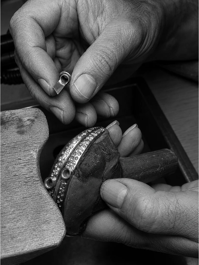 Close-up of a KELARE bracelet hinge, clasp and safety system being adjusted by hand