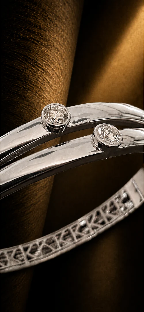 Close-up of PURE in white gold showing the two principal diamonds and internal K frieze