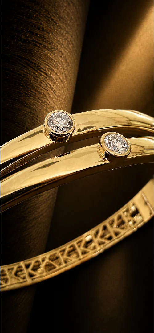 Close-up of PURE in yellow gold showing the two principal diamonds and internal K frieze